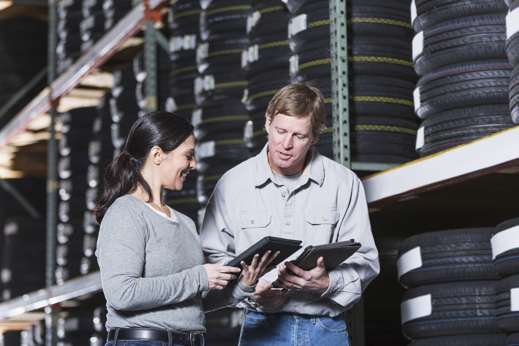 Workers in warehouse with tires counterpoint retail pos