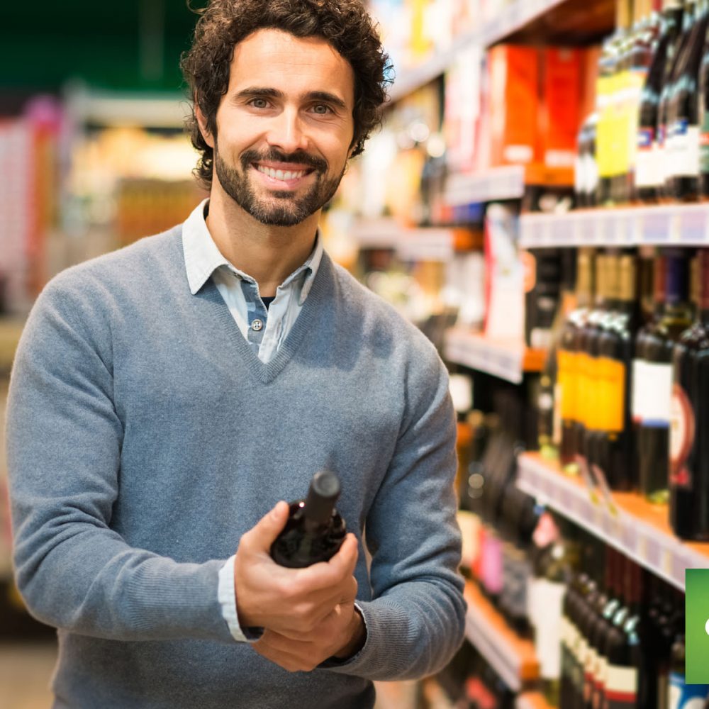 man holding wine bottle near store shelf using counterpoint commerce