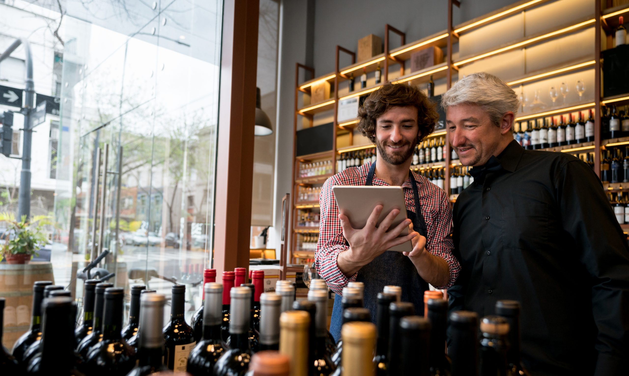 ncr counterpoint retail pos for liquor store managers looking at wine bottles