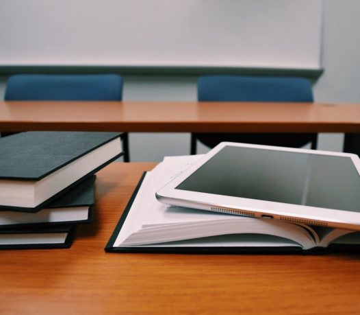 college student books and ipad laying ontop